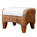 Woven ottoman with a white cushion on a white background