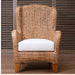 Woven armchair with a white cushion against a wooden background