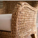 Close-up of a wicker chair with a white cushion