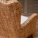 Woven chair with a cushion in a room setting