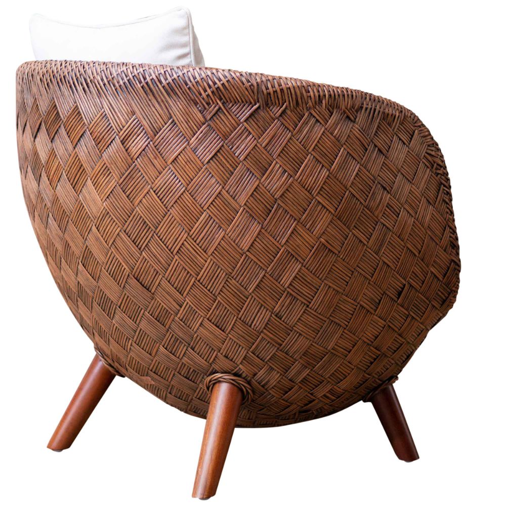 Woven wooden chair with a white cushion on a white background