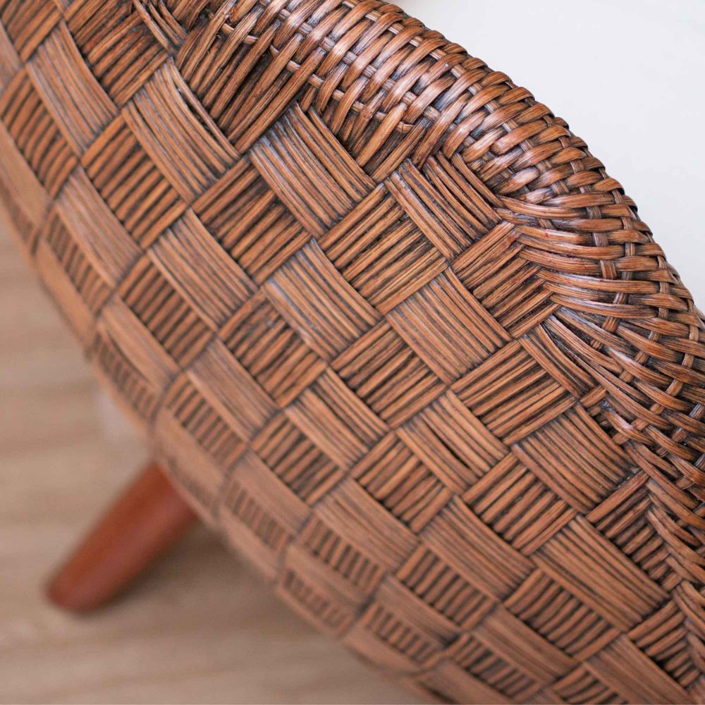 Close-up of a wicker chair seat with a blurred background