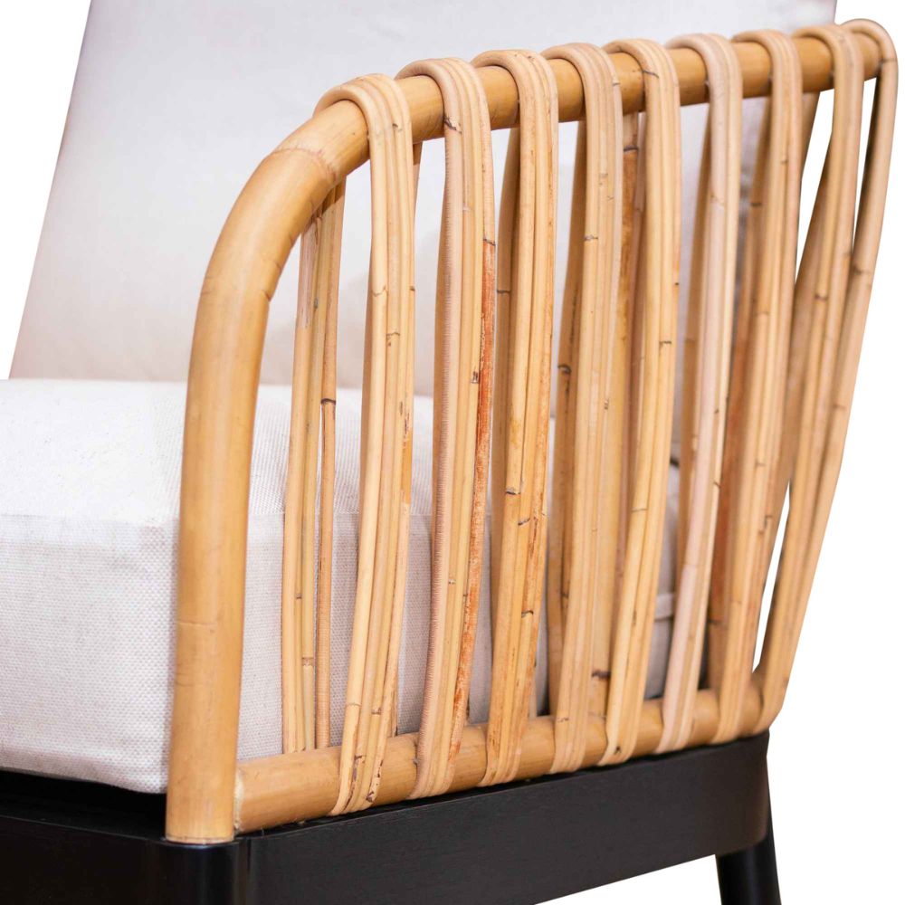 Close-up of a rattan crib with a white mattress on a white background