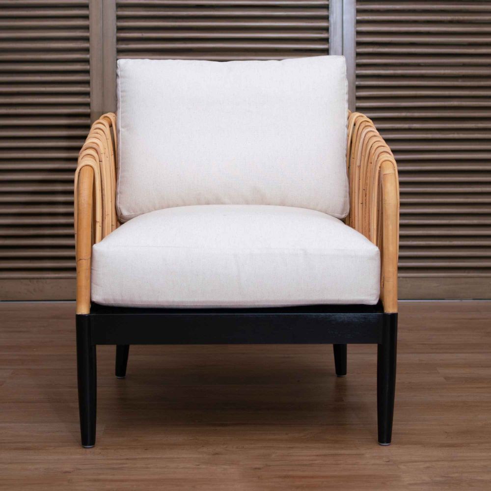 Chair with white cushion and wooden frame against a wooden panel background