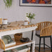 Dining area with a wooden table, chairs, and decorative items.