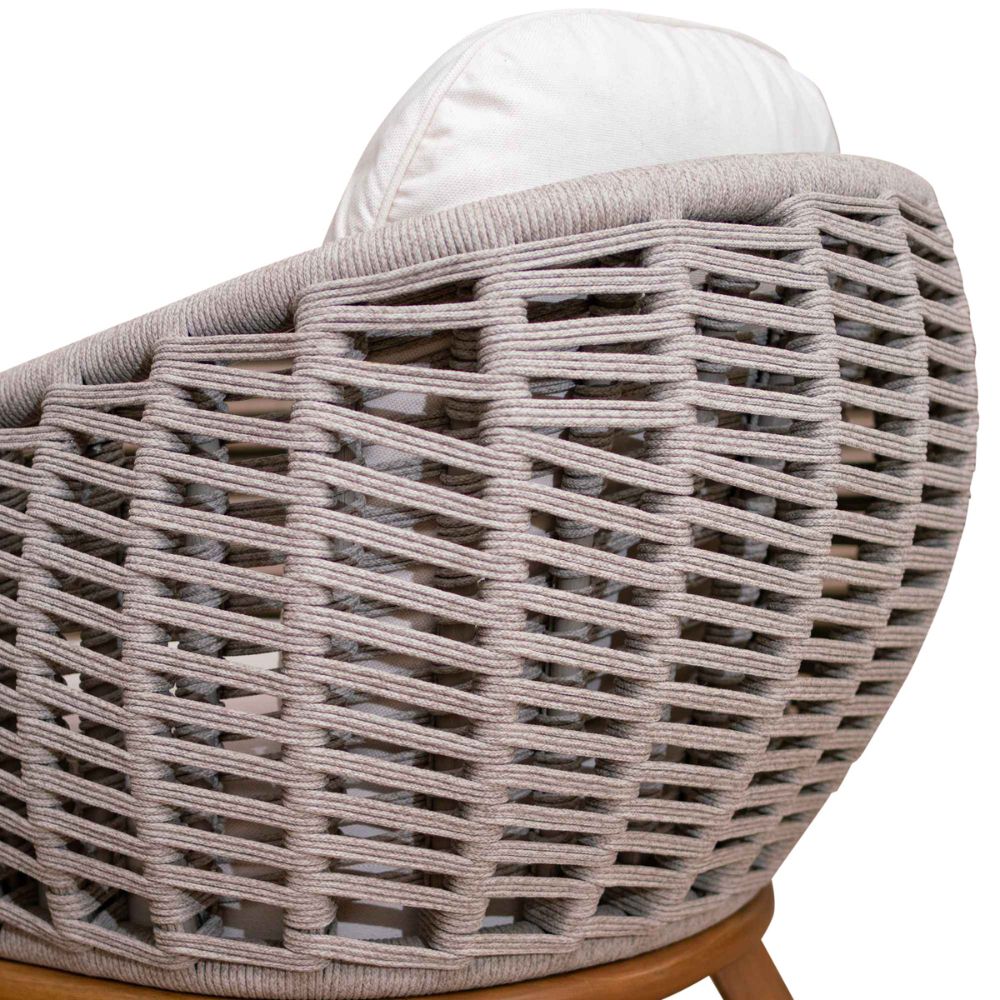 Wicker chair with a white cushion on a white background