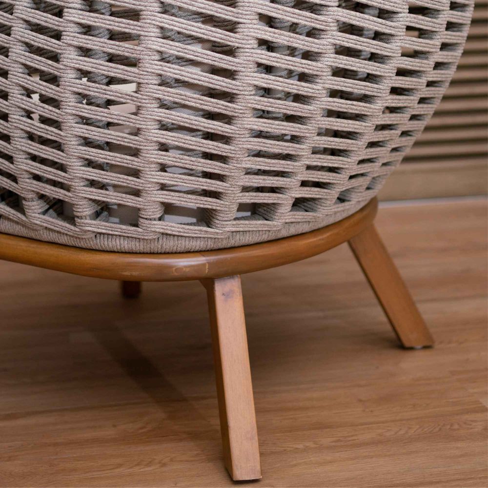 Wicker chair with wooden legs on a wooden floor