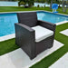 Wicker chair with white cushion by a poolside