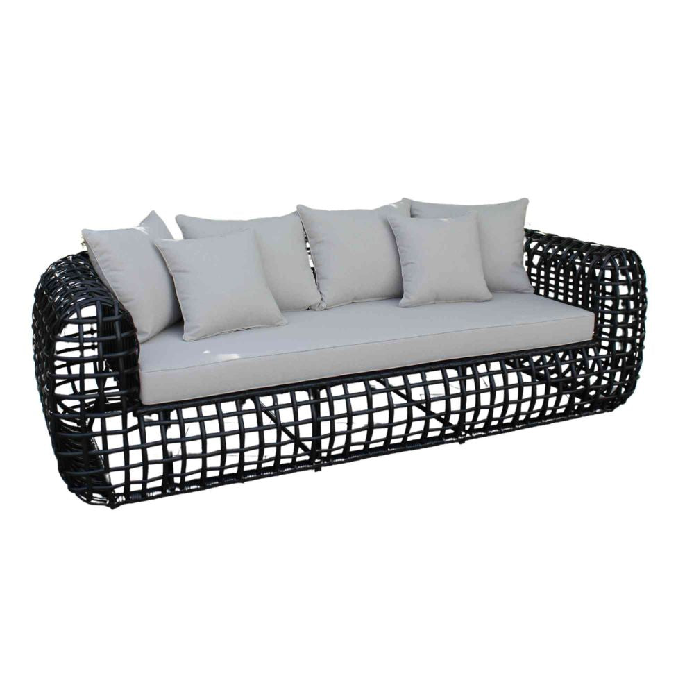 Black wicker outdoor sofa with light gray cushions on a white background