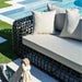 Outdoor sofa with cushions by a poolside