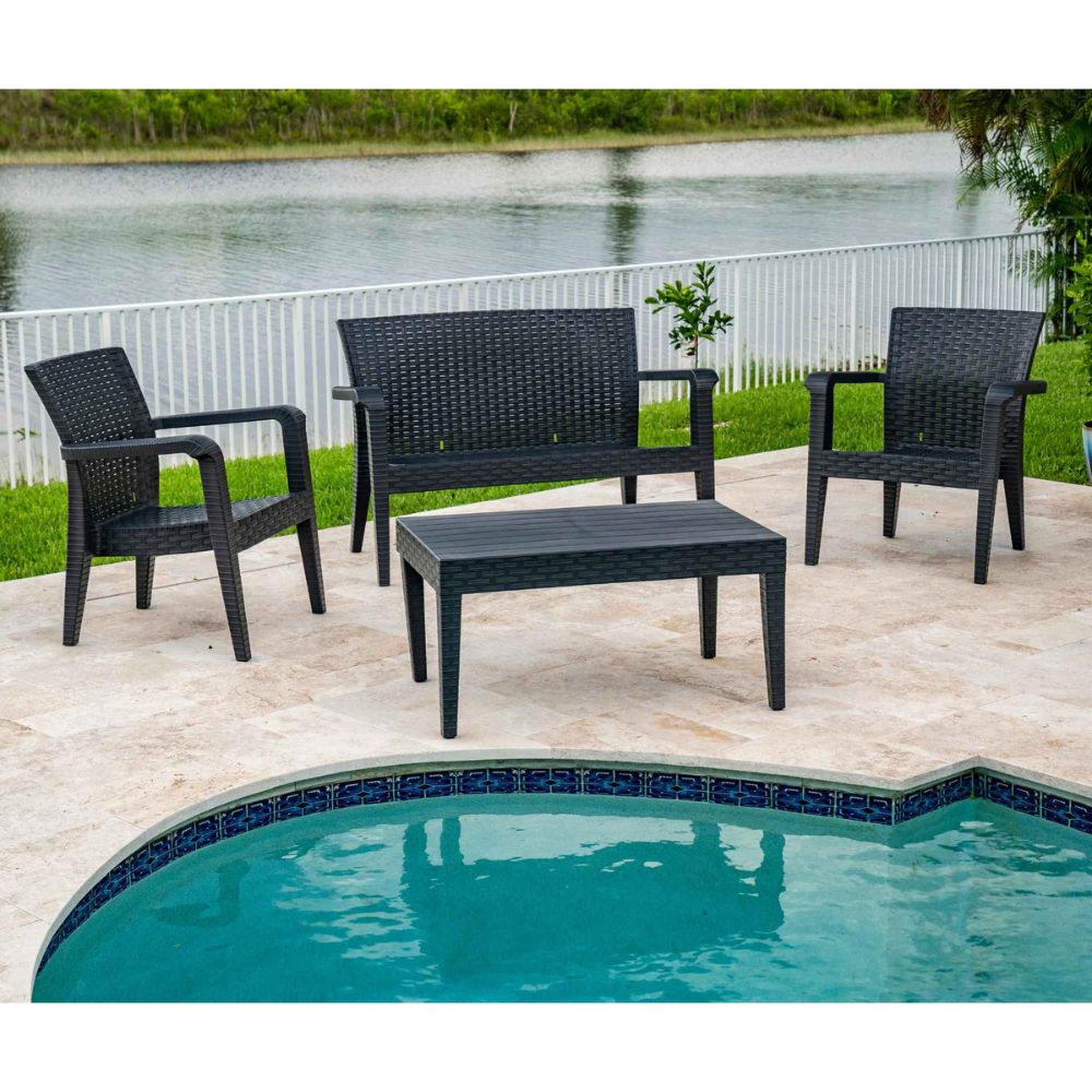 Black outdoor furniture set with chairs and a table by a poolside.