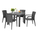 Gray outdoor dining table with four matching chairs on a white background