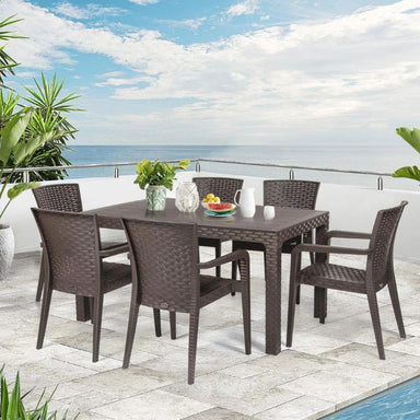 Outdoor patio set with table and chairs on a stone patio with ocean view