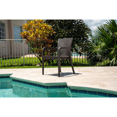 Chair by a pool with greenery in the background
