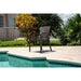 Chair by a pool with greenery in the background