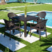 Outdoor patio set with table and chairs by a pool