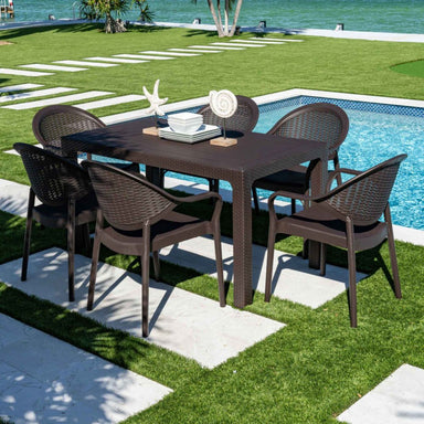 Outdoor dining set with table and chairs by a poolside