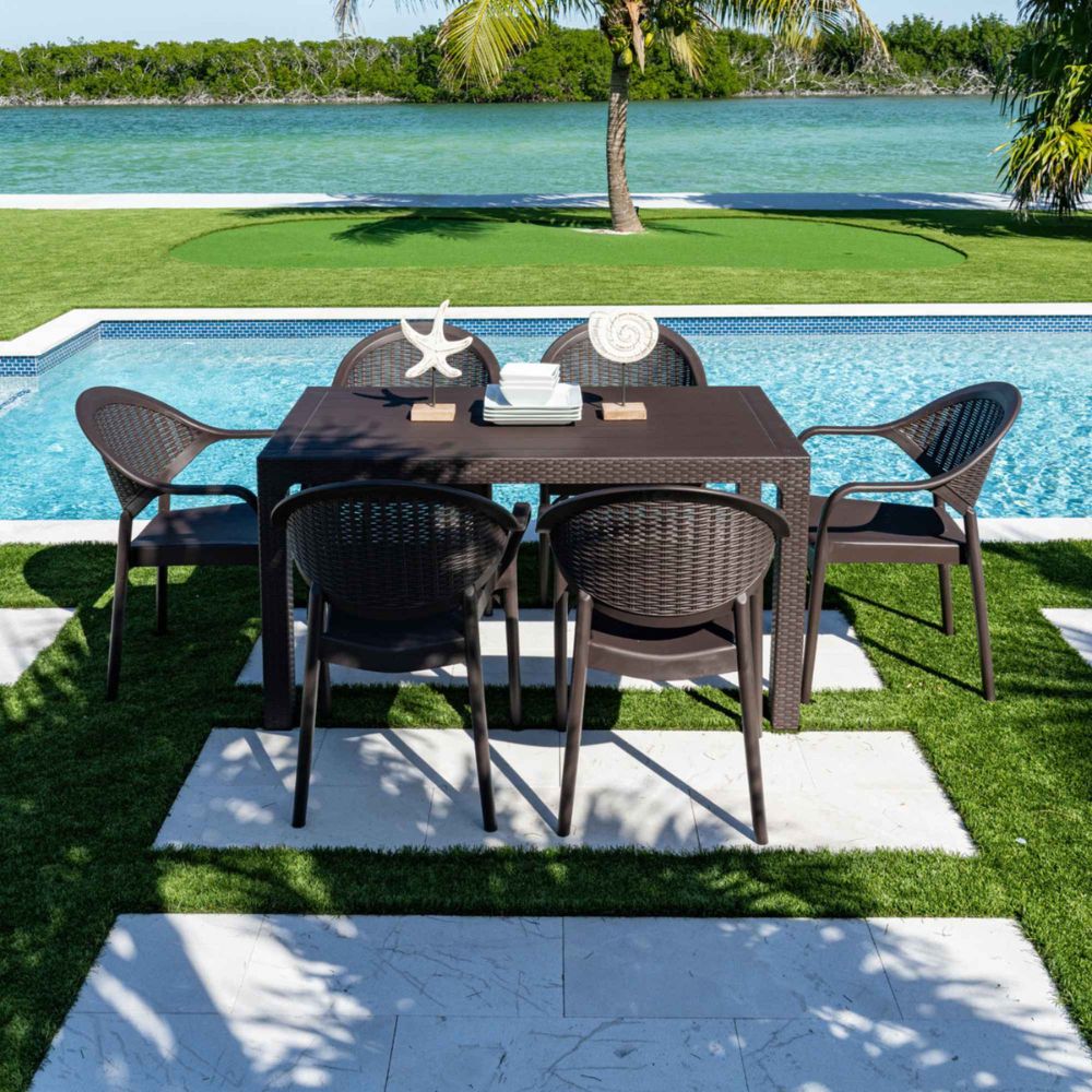 Outdoor dining set with table and chairs by a poolside