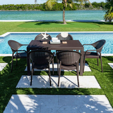 Outdoor dining set with table and chairs by a poolside