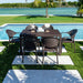Outdoor dining set with table and chairs by a poolside