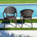 Two brown wicker chairs by a poolside on a sunny day.