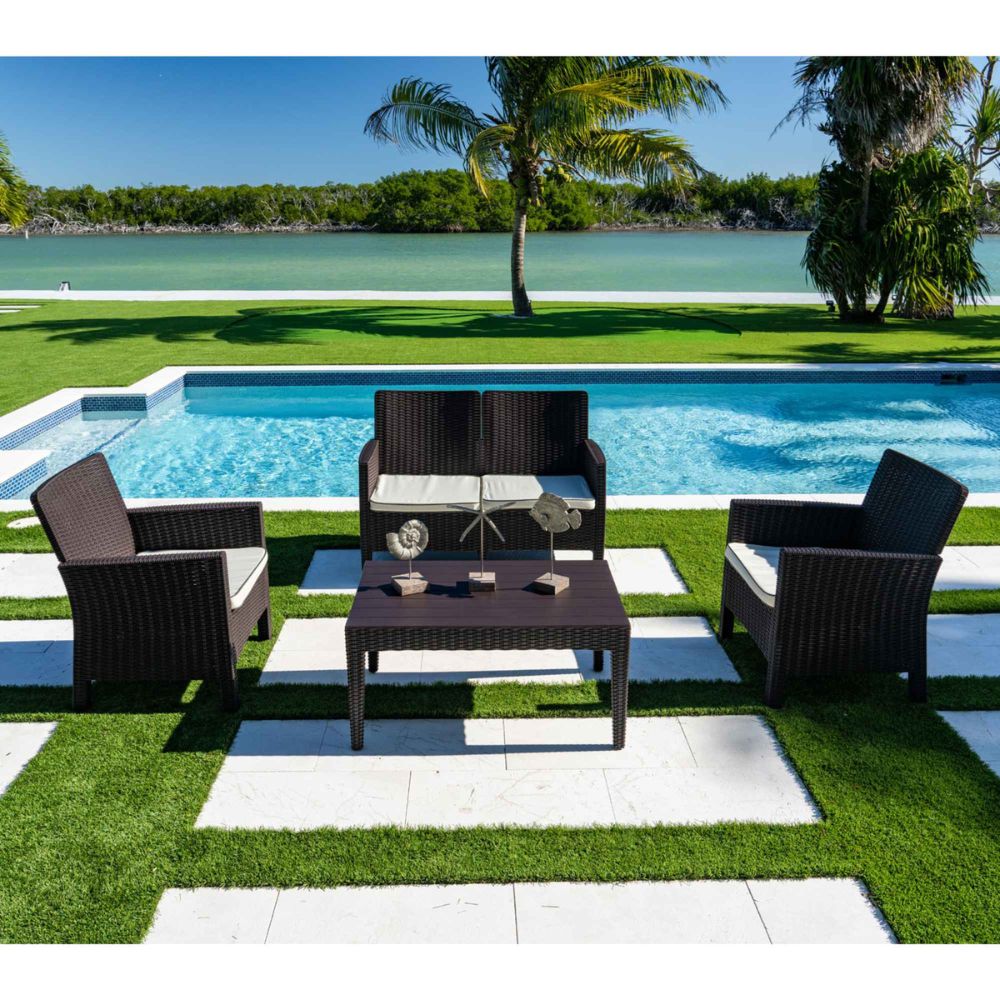 Outdoor patio set with chairs and table by a poolside