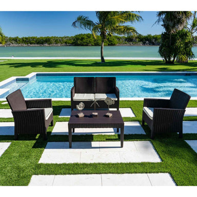 Outdoor patio set with chairs and table by a poolside