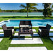 Outdoor patio set with chairs and table by a poolside