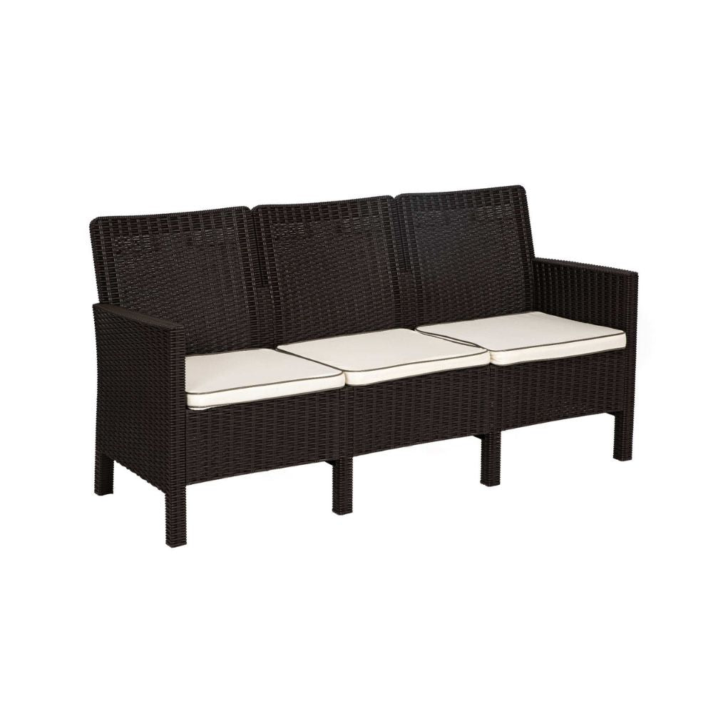 Black wicker outdoor sofa with white cushions on a white background