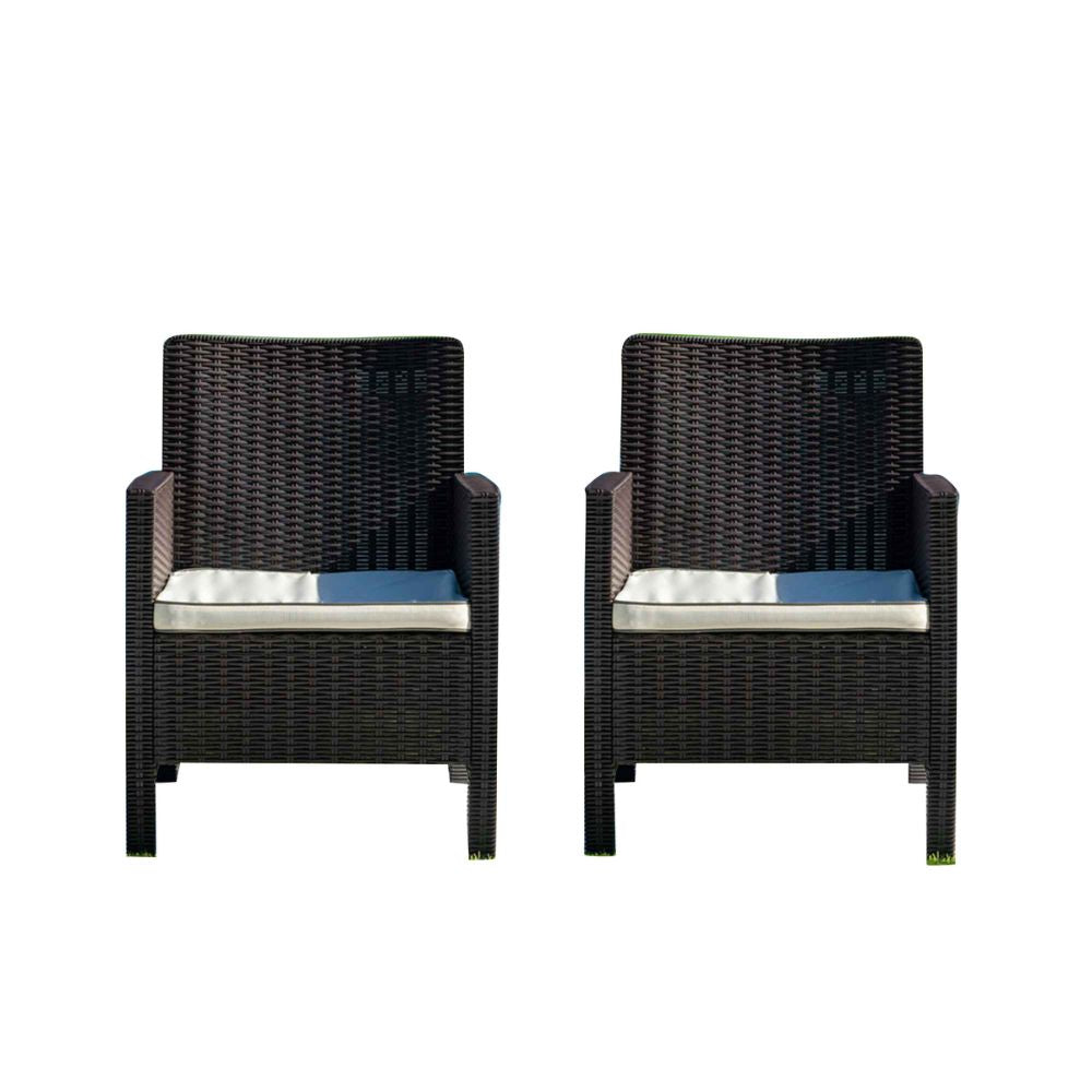 Two black wicker chairs with blue cushions on a white background