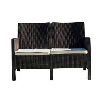Black wicker outdoor sofa with cushions on a white background