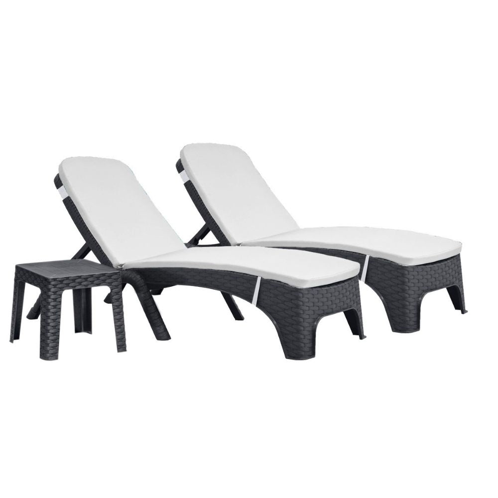 Two black wicker lounge chairs with white cushions on a white background