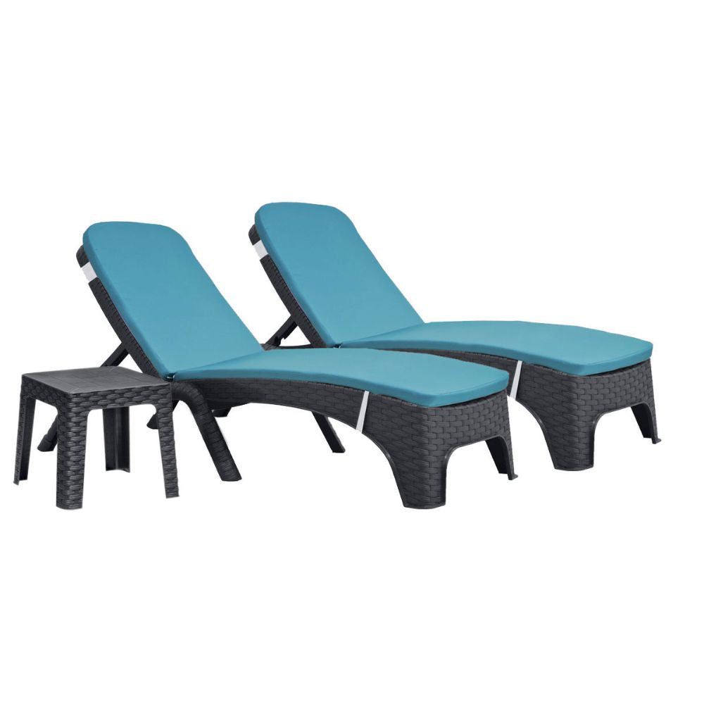 Two blue cushioned lounge chairs with a small table on a white background