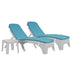 Two blue cushioned lounge chairs with white frames on a white background