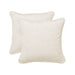 Two beige pillows on a white background